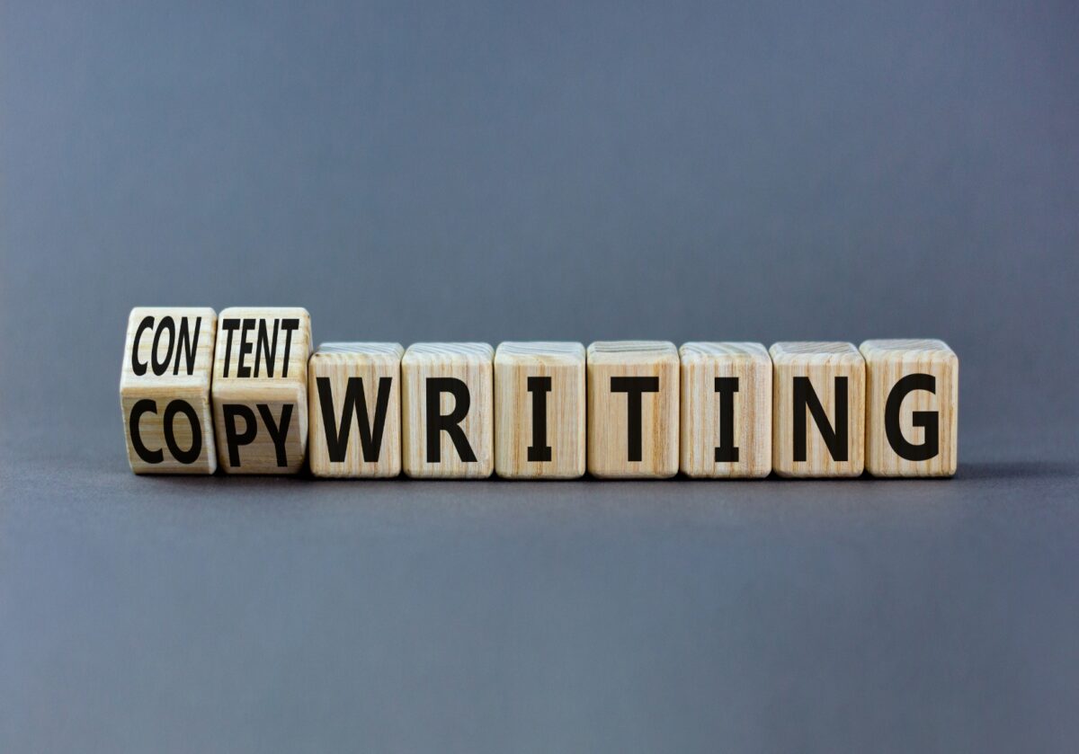 Wooden cubes on a gray background that spell out Content Writing.