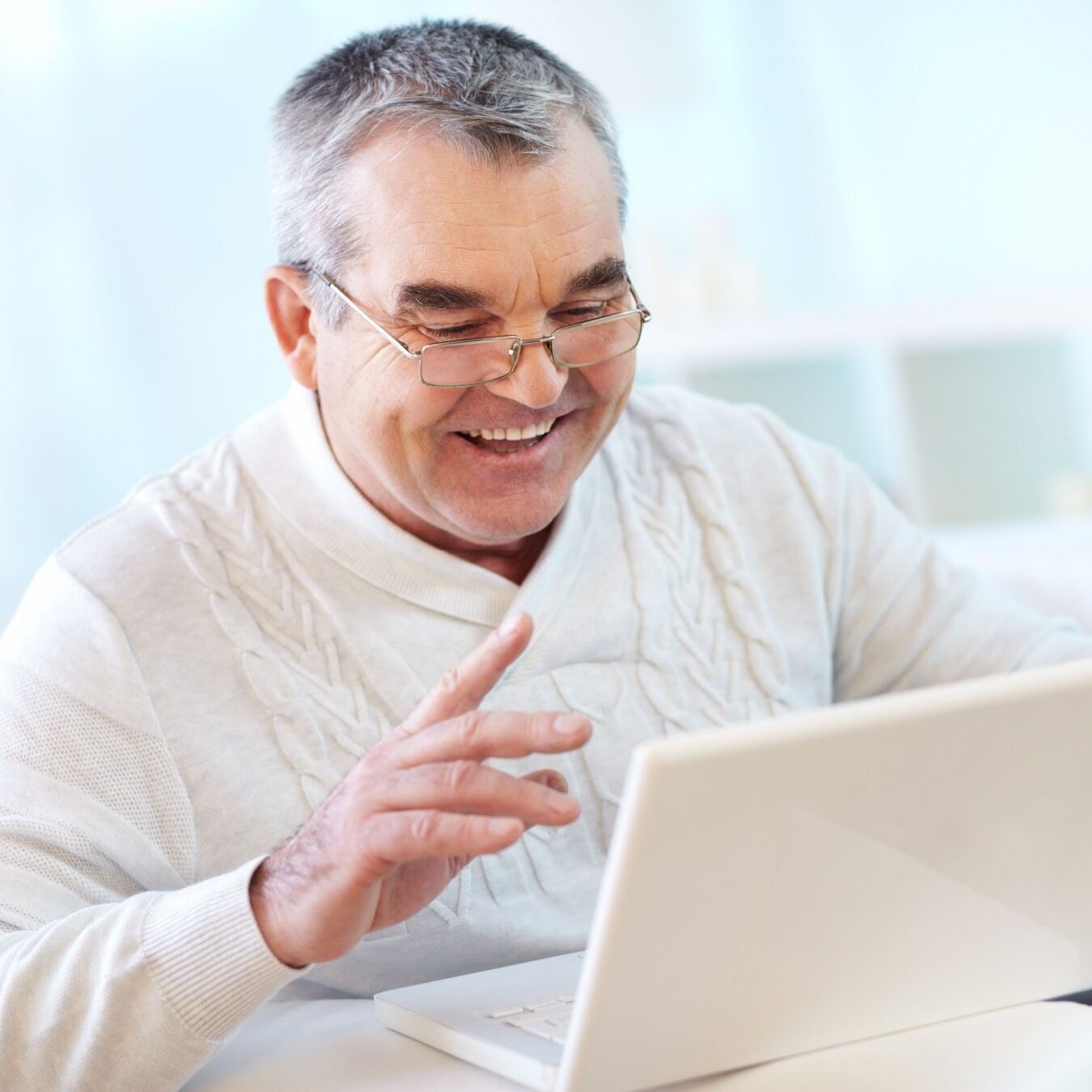 A man on his laptop in his home office requests his slide deck.